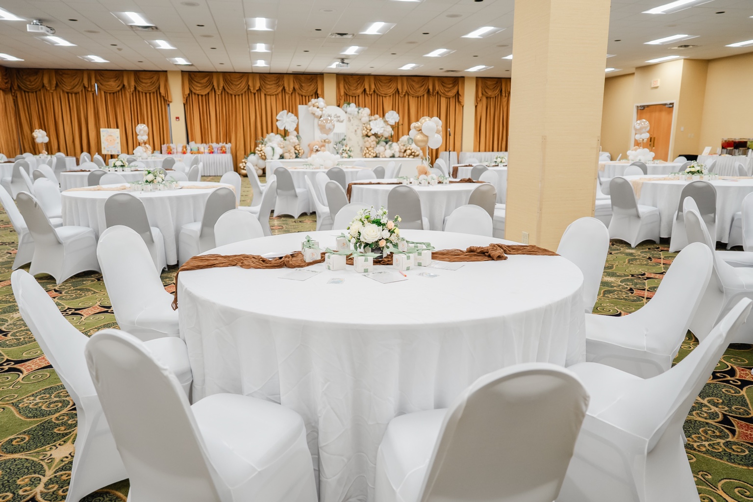 A place for everyone: white and gold baby shower decor at Whispering Woods
